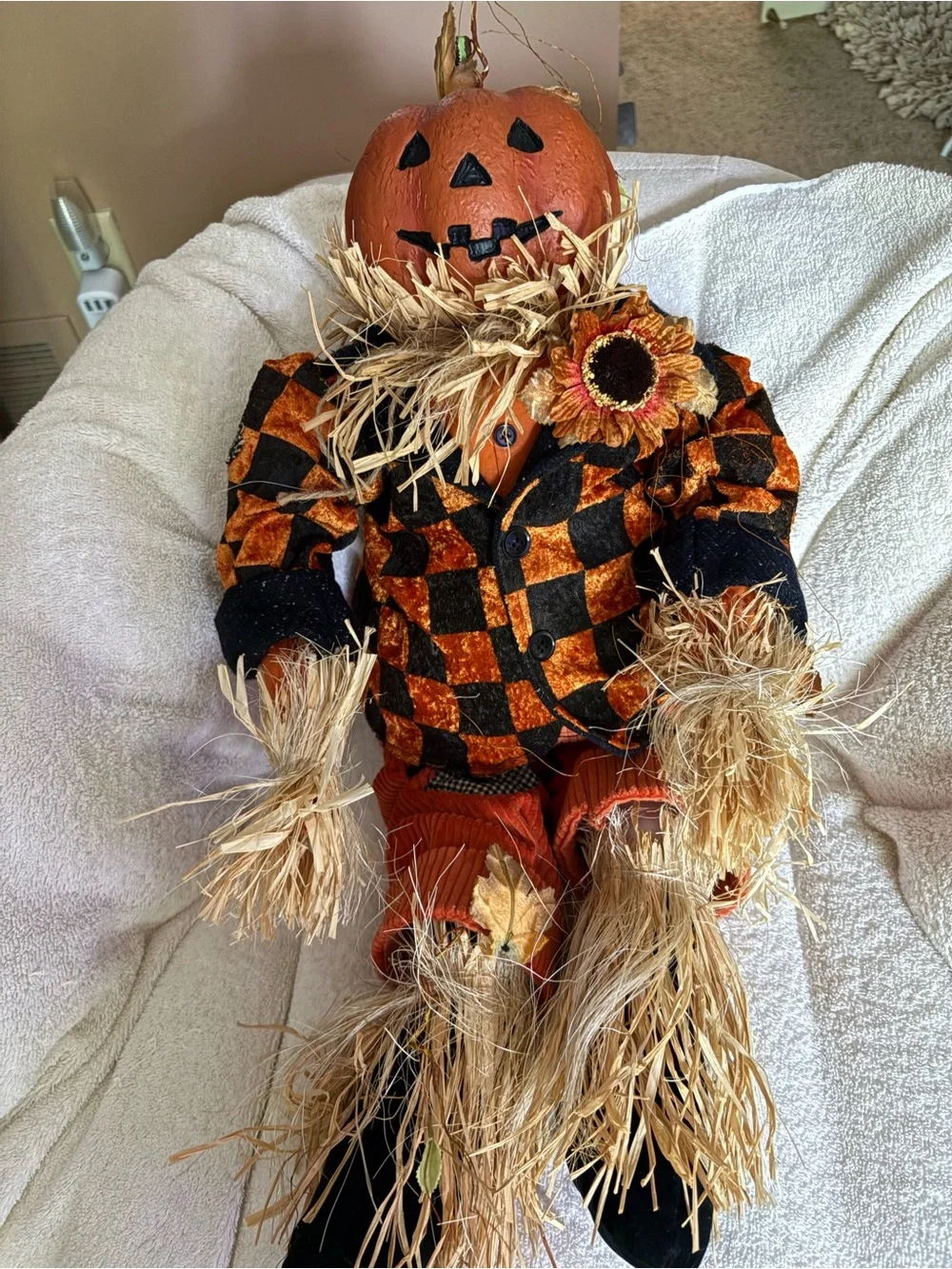 Cute resin head pumpkin doll with checkered jackets, cords, & straw accents.